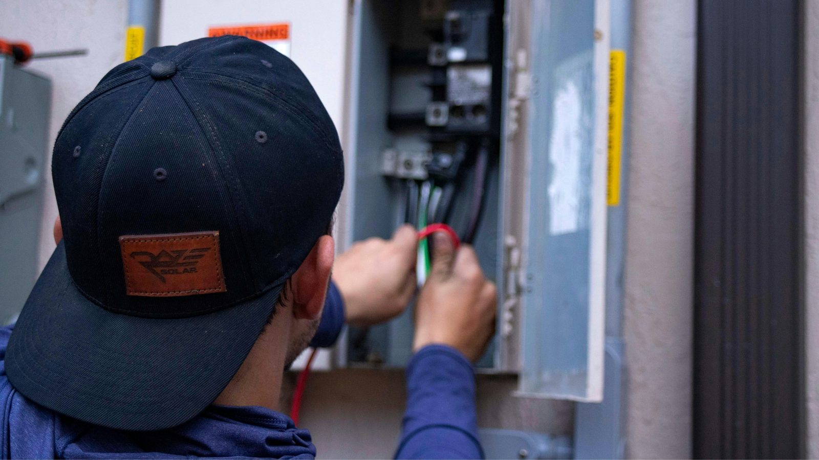 Licensed electrician wiring a solar electrical panel